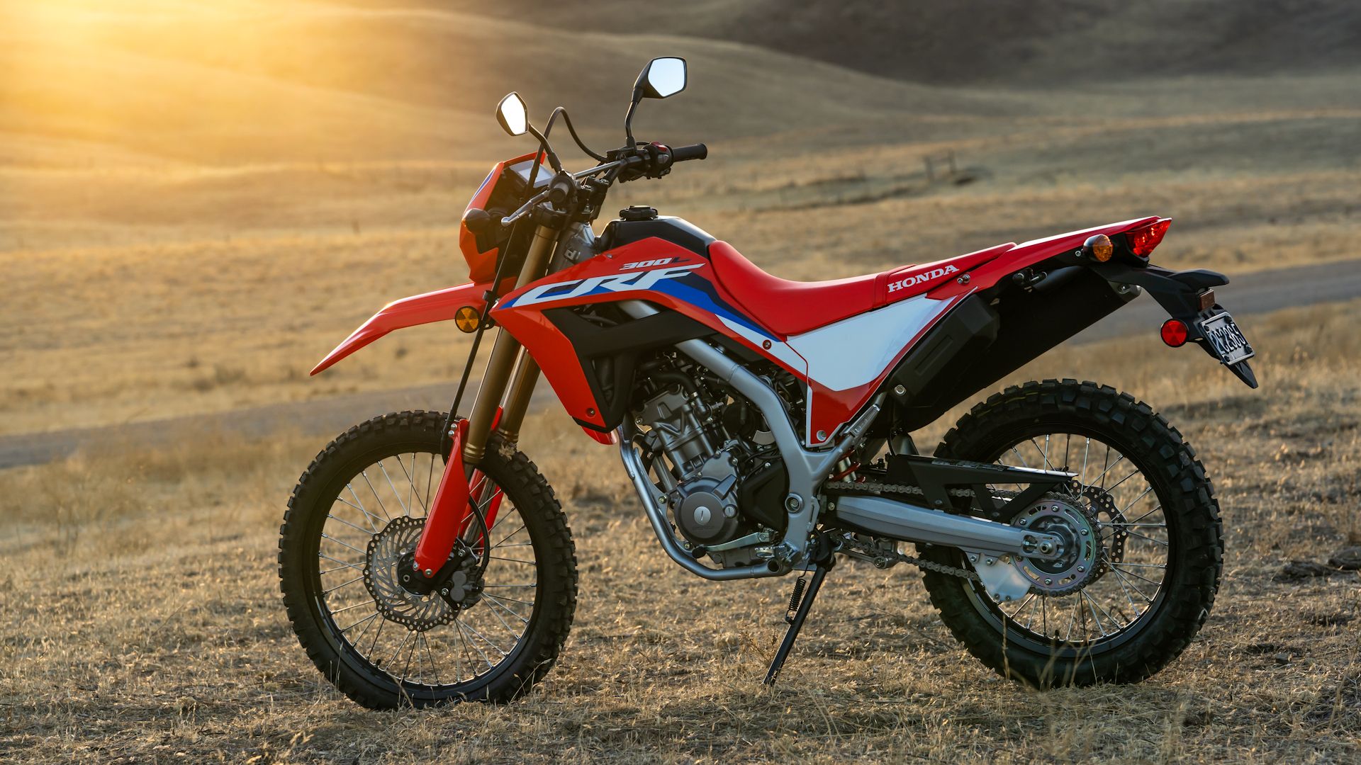 Red 2021 Honda CRF300L  parked in a field