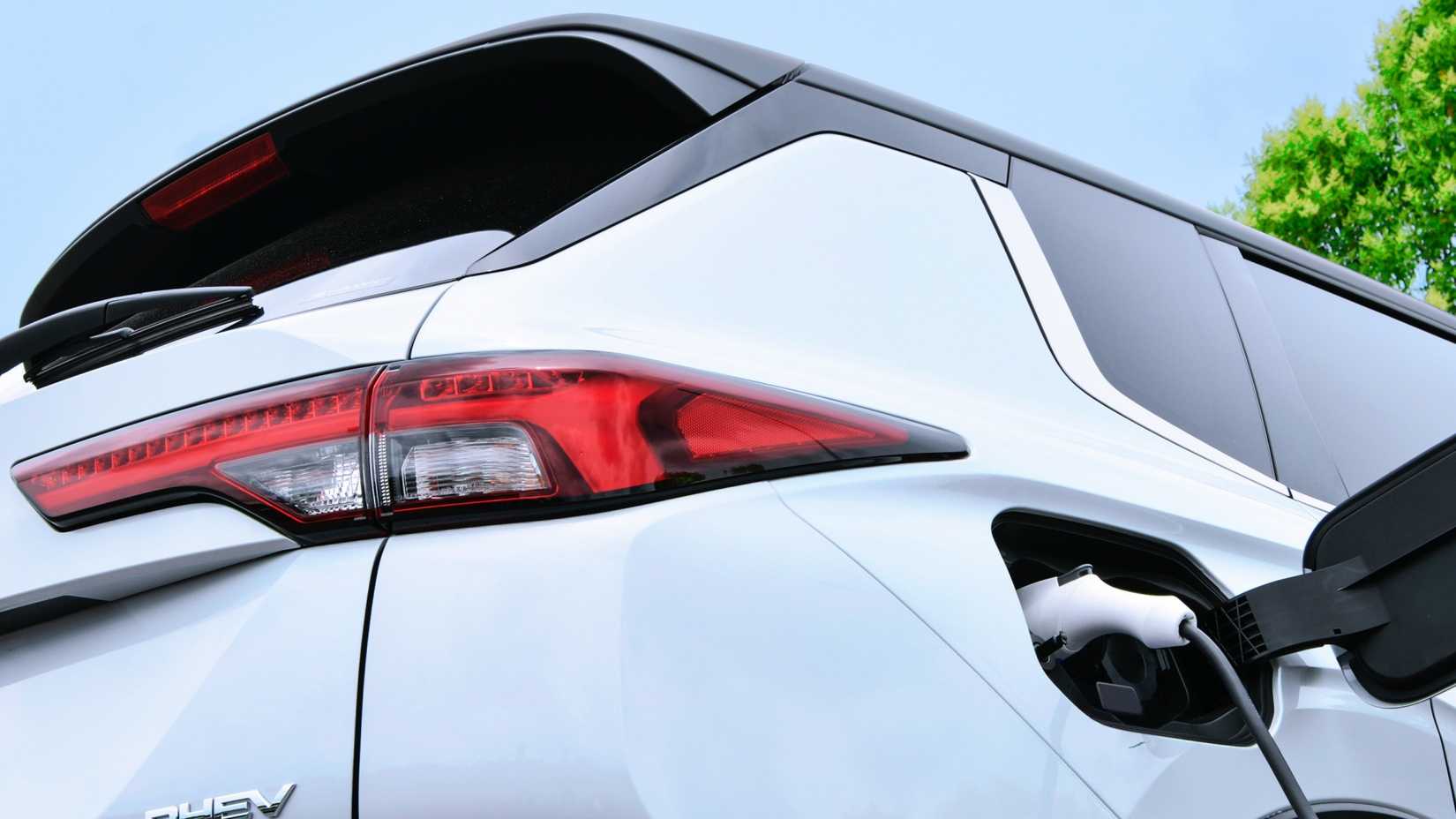 A shot of a white 2023 Mitsubishi Outlander PHEV charging