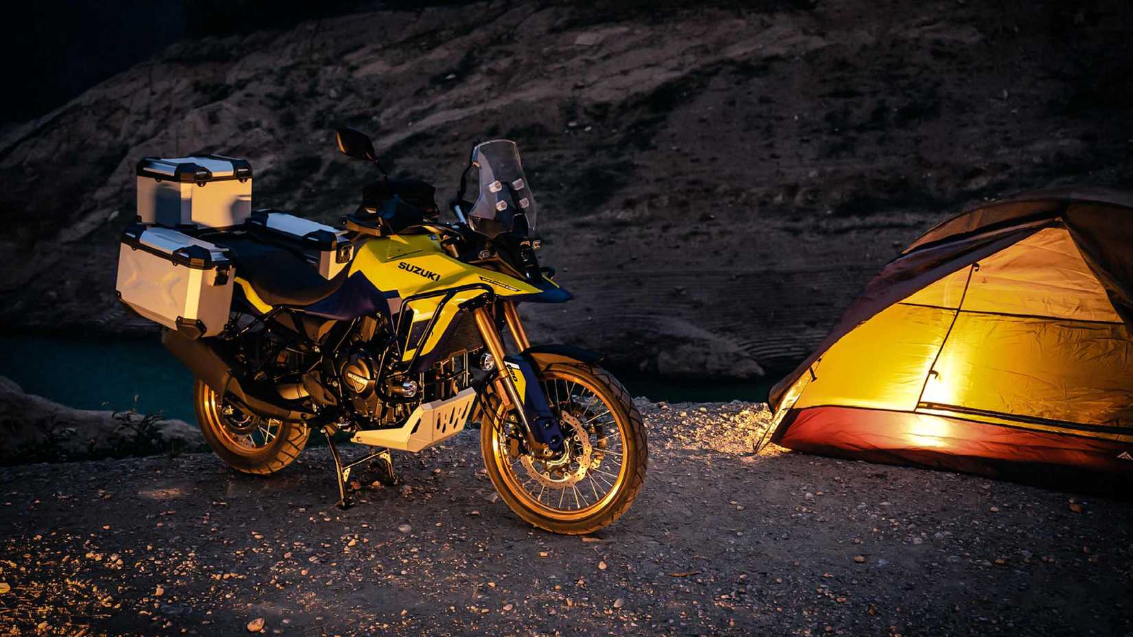 Yellow 2023 Suzuki V-Strom 800DE Adventure at a campsite