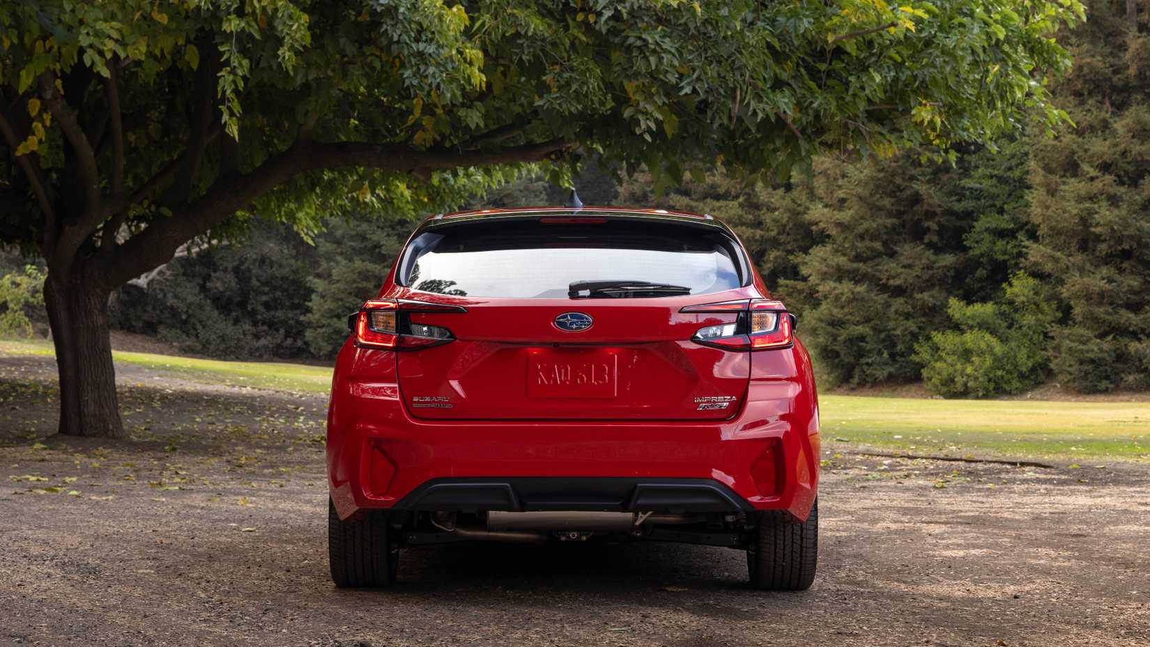 Red 2024 Subaru Impreza RS in a forest rear shot