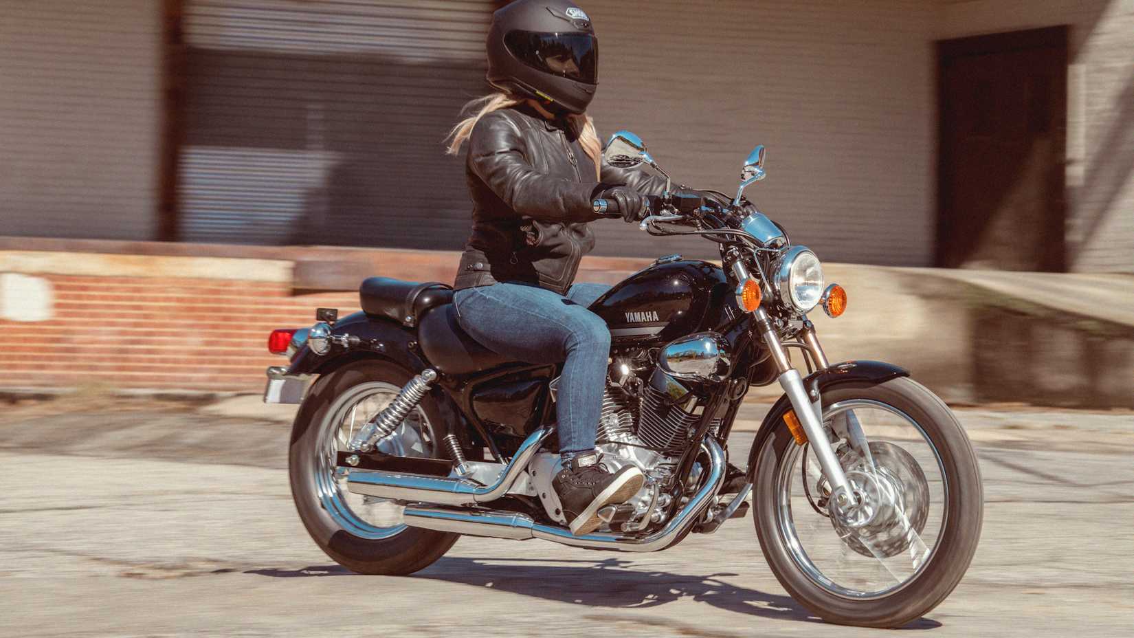 Black Yamaha V-Star 250 cruising through a parking lot
