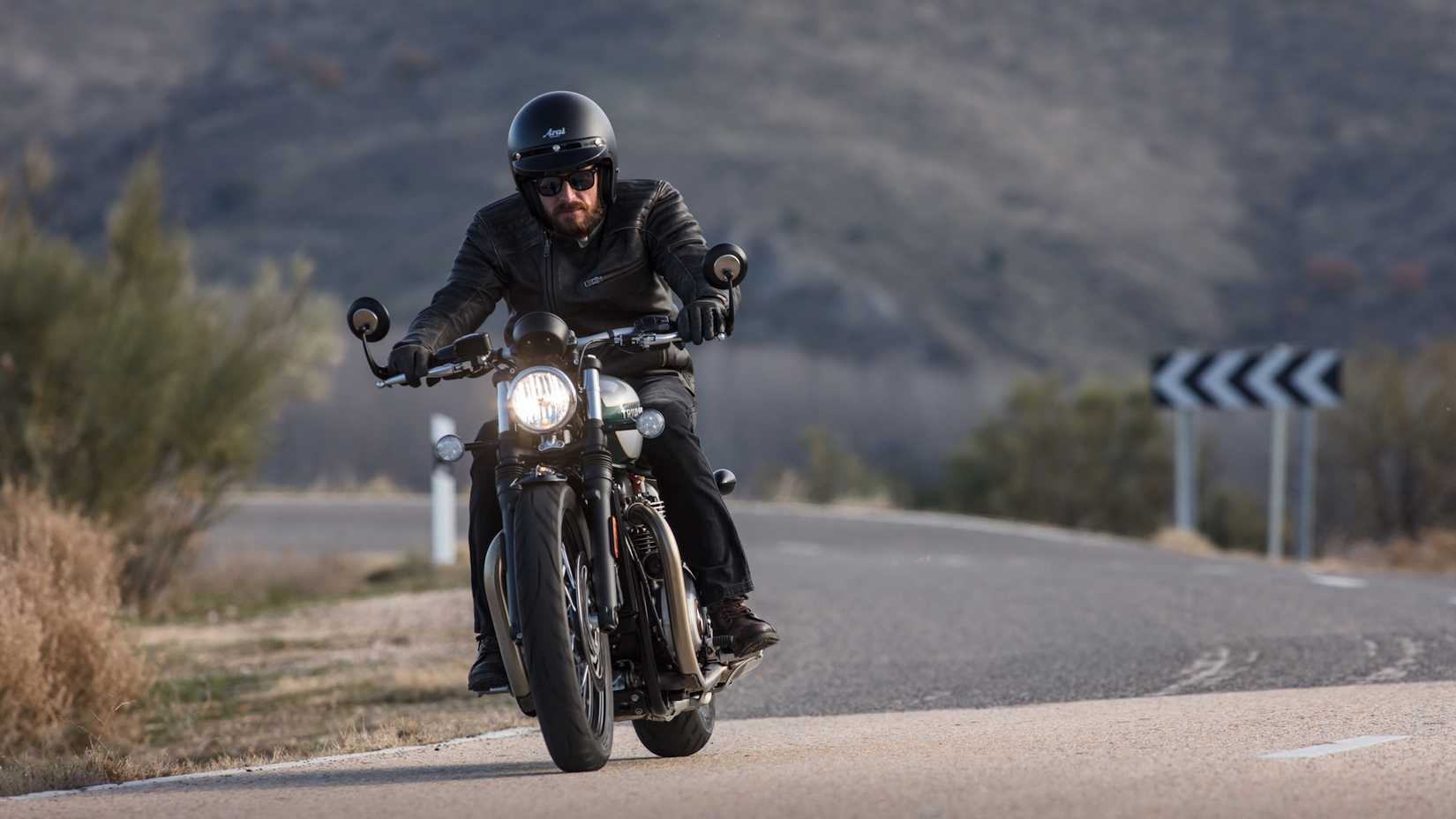 Gray 2021 Triumph Bonneville Bobber coming out of a curve