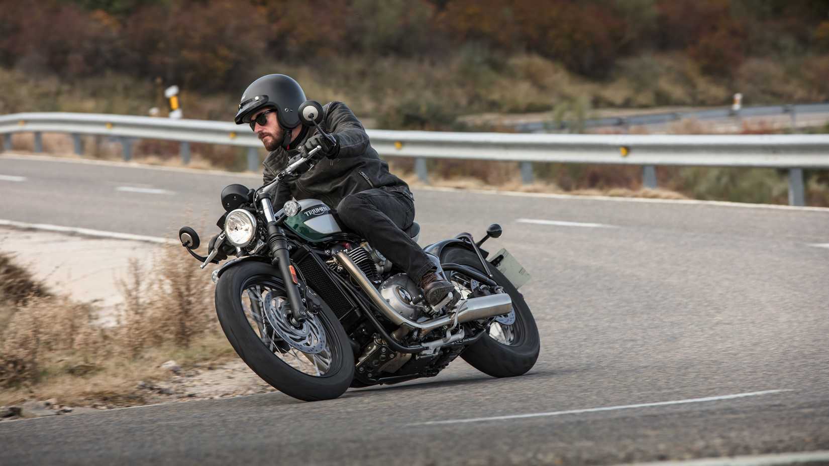 Gray  Triumph Bonneville Bobber leaning into a curve