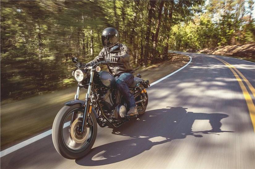 Front angle of a rider on the 2025 Yamaha Bolt R-Spec driving through the woods.