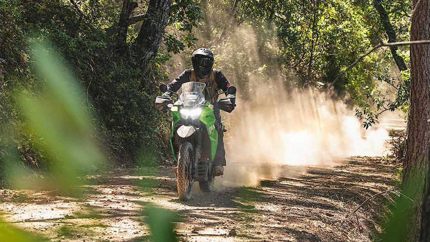 An action shot of the 2023 Kawasaki KLR650 on a trail