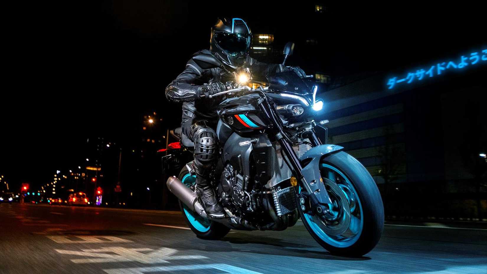 Action shot of the 2023 Yamaha MT-10 naked bike at night from a front three-quarter view.
