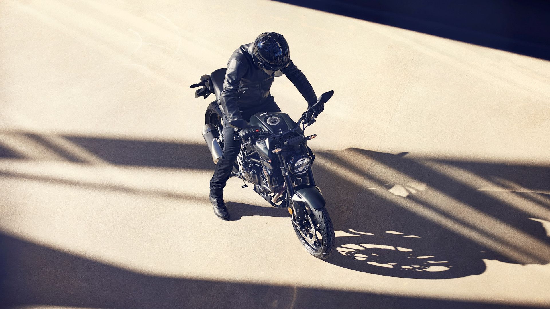 Black Honda CB300R parked on an empty lot in overhead view