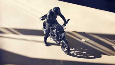 Black Honda CB300R parked on an empty lot in overhead view