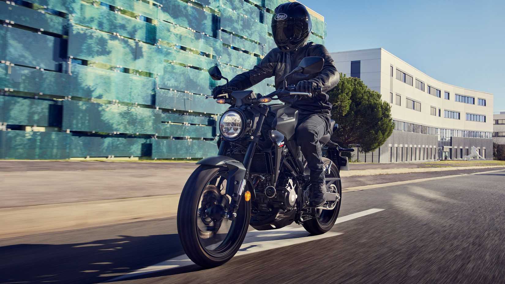 Black 2022 Honda CB300R cruising down a road