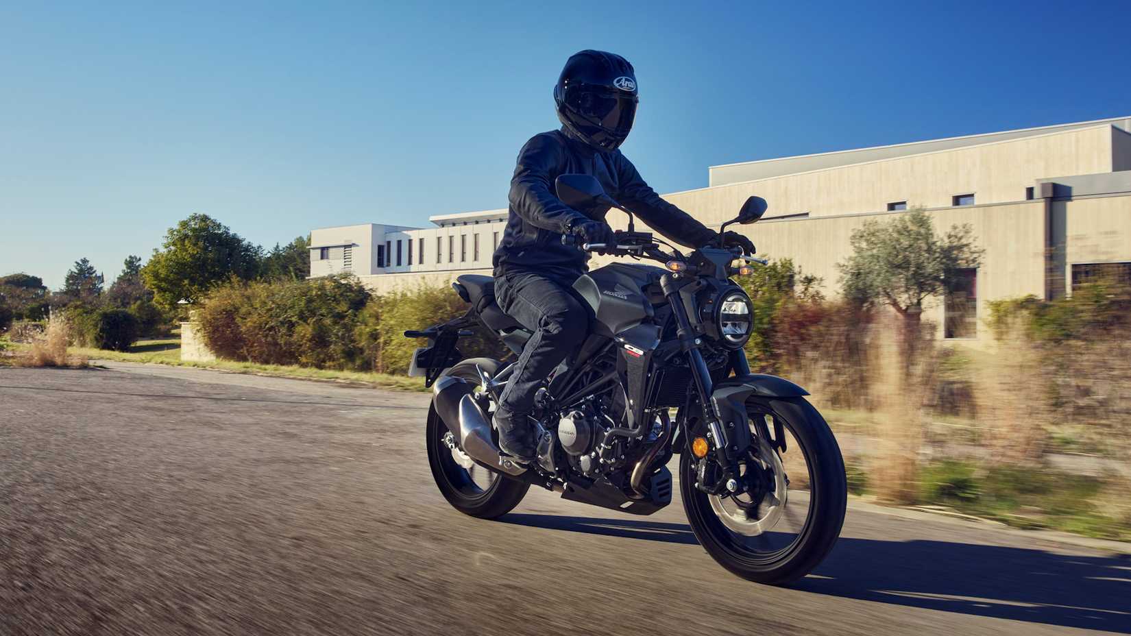 Black Honda CB300R sails a road