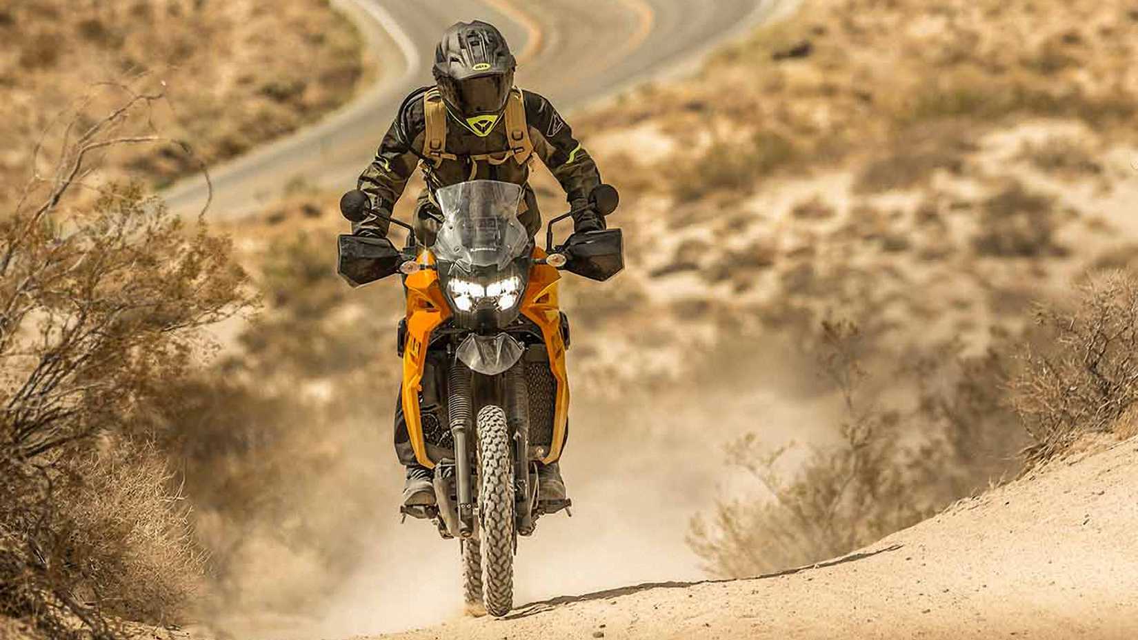 Yellow 2023 Kawasaki KLR650 Traveler on a trail