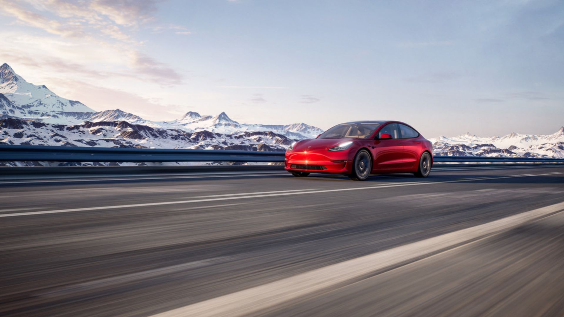 Red Tesla Model 3 em uma estrada de montanha