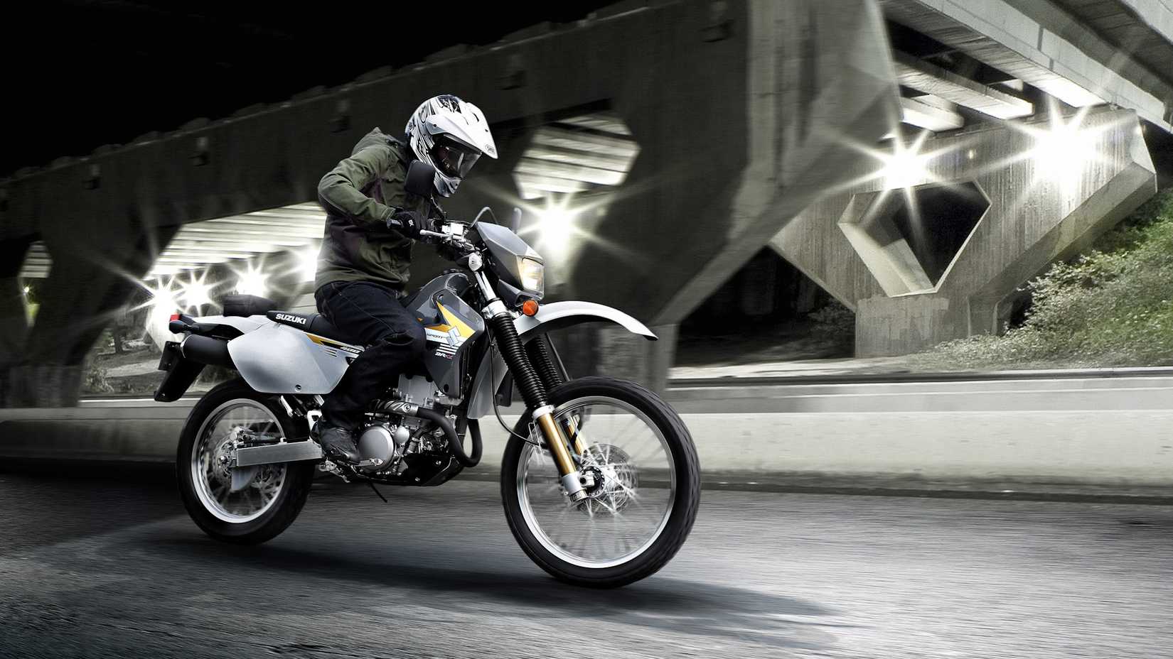 White 2019 Suzuki DR-Z400S cruising under an overpass