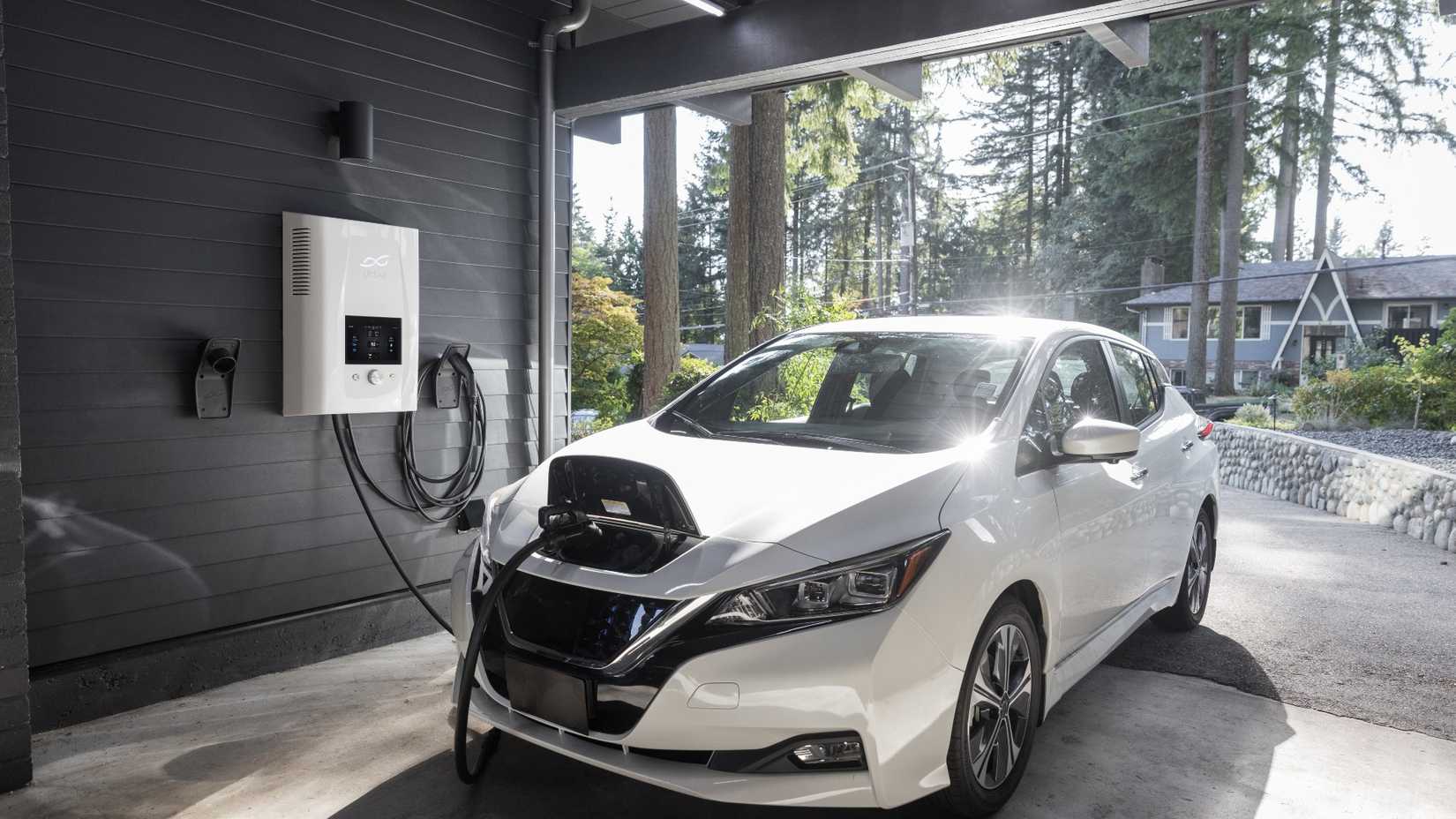 White EV charging at home garage