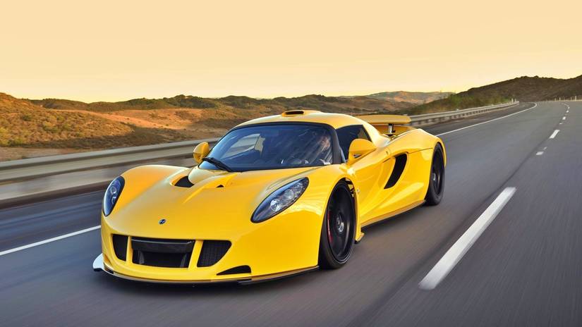 2011 Hennessey Venom GT in yellow driving on desert road