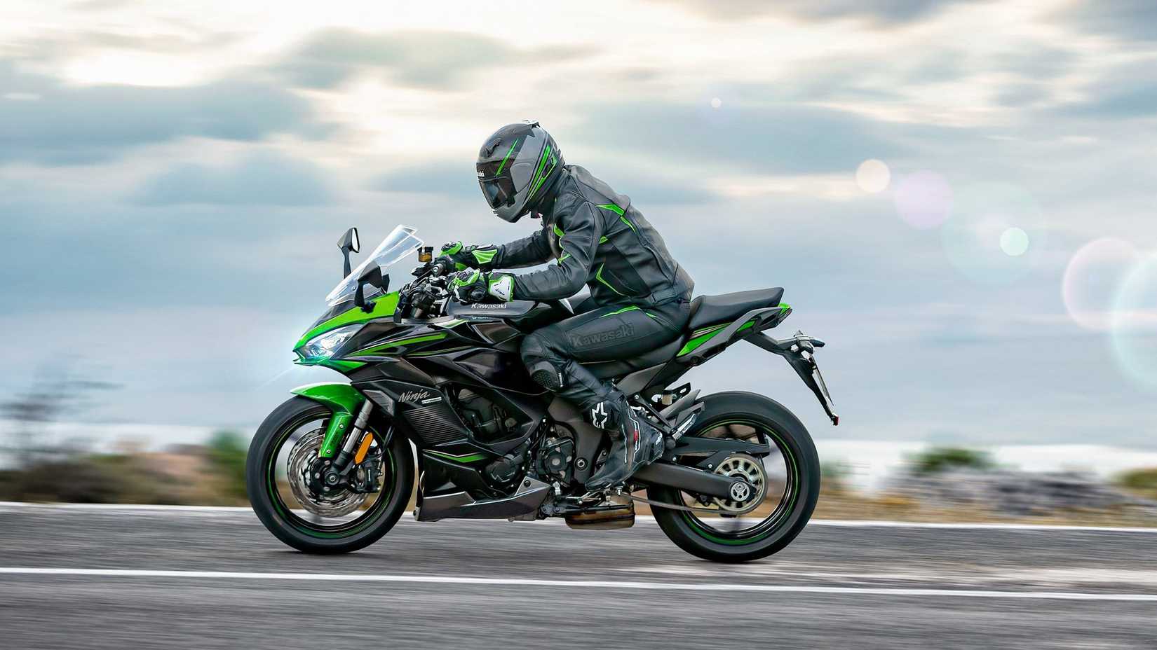 Green 2023 Kawasaki Ninja 1000SX cruising on the road