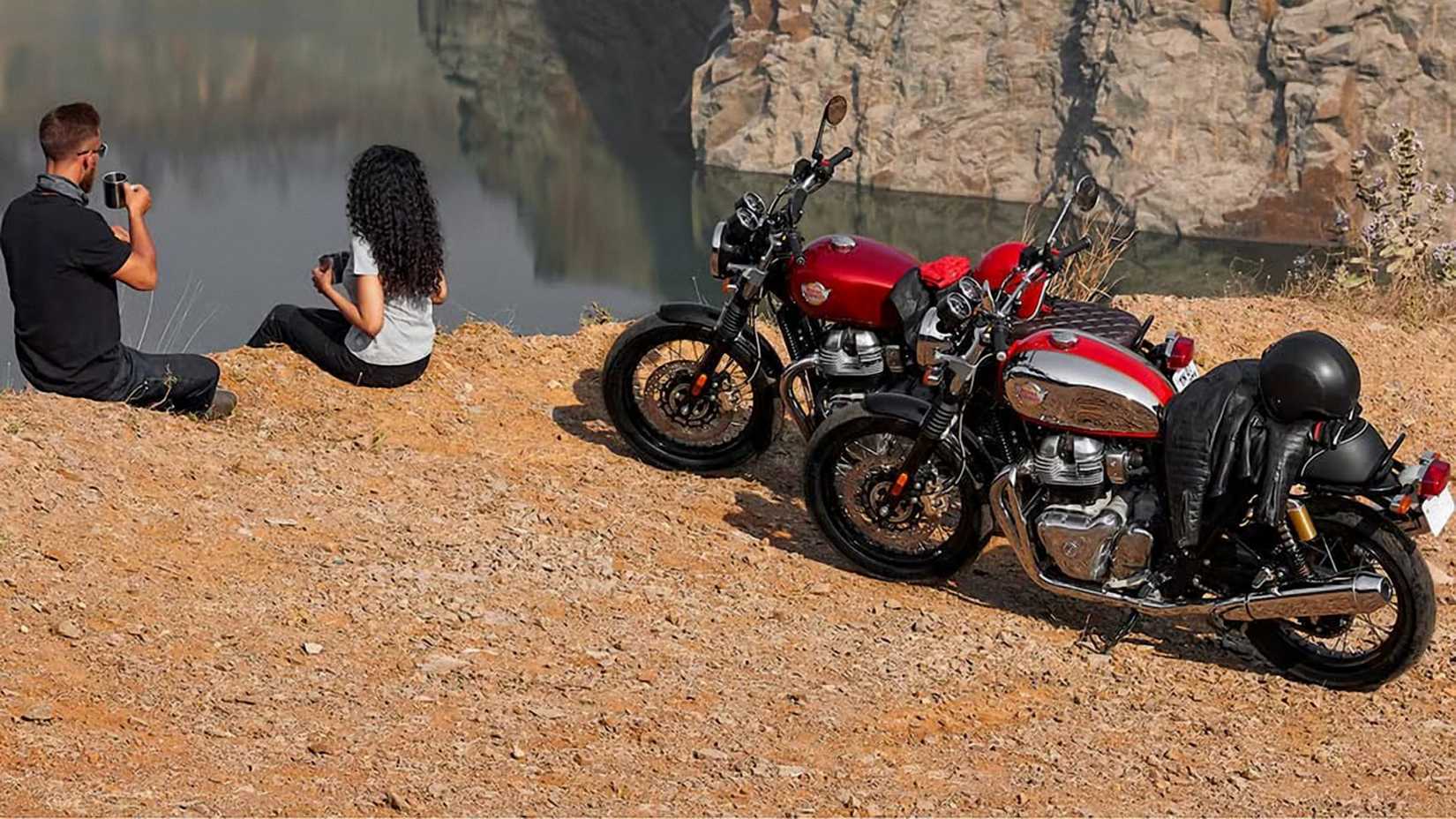 Riders taking a break next to a pair of 2023 Royal Enfield INT650 motorcycles