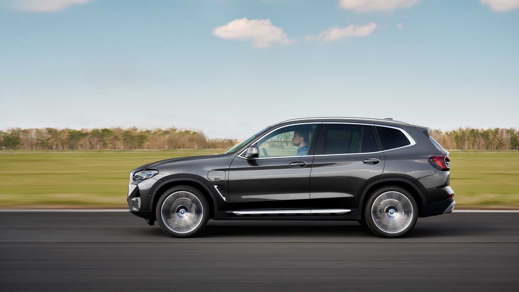 2023 BMW X3 side shot driving down the road