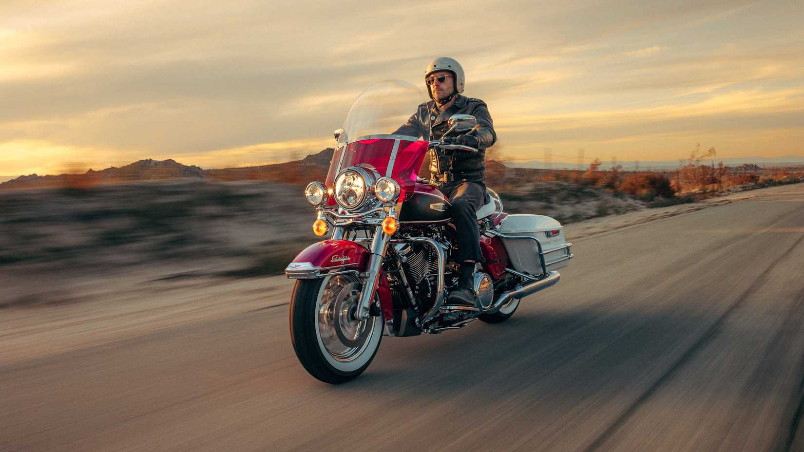 Magenta 2023 Harley-Davidson Electra Glide Highway King cruising on the highway