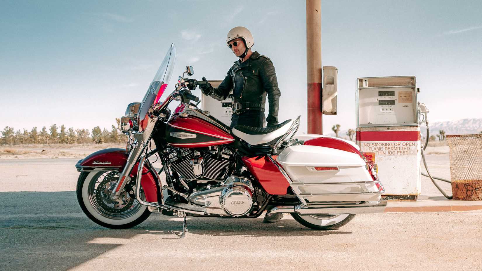 Rider stands next to a magenta 2023 Harley-Davidson Electra Glide Highway King
