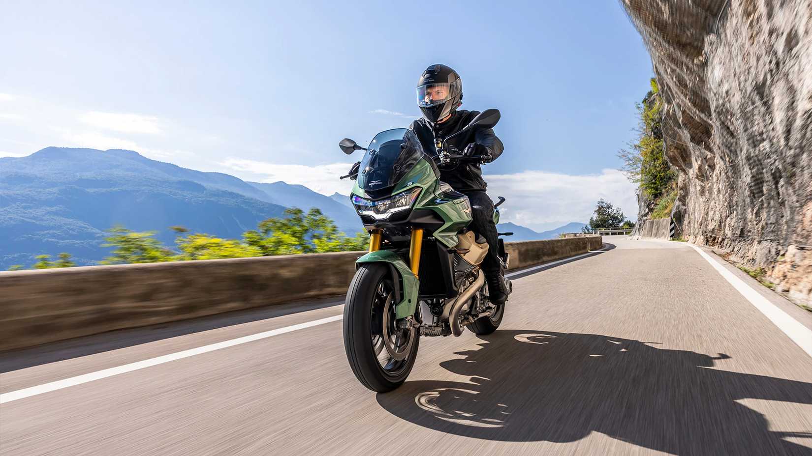 Moto Guzzi V100 Mandello S action shot of front left three quarter on a mountain road
