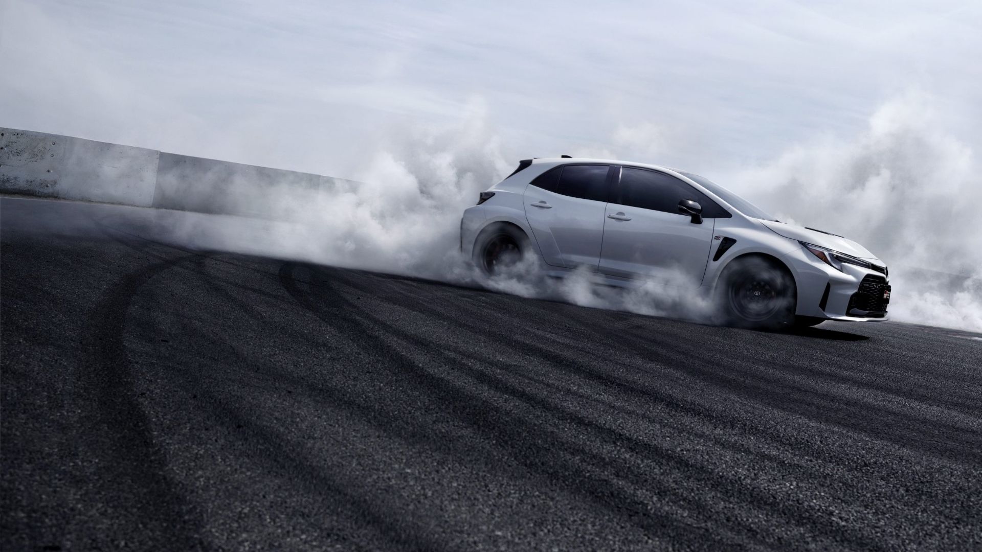 Side shot of a 2023 Toyota GR Corolla drifting on track