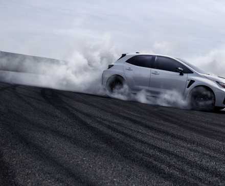 Side shot of a 2023 Toyota GR Corolla drifting on track