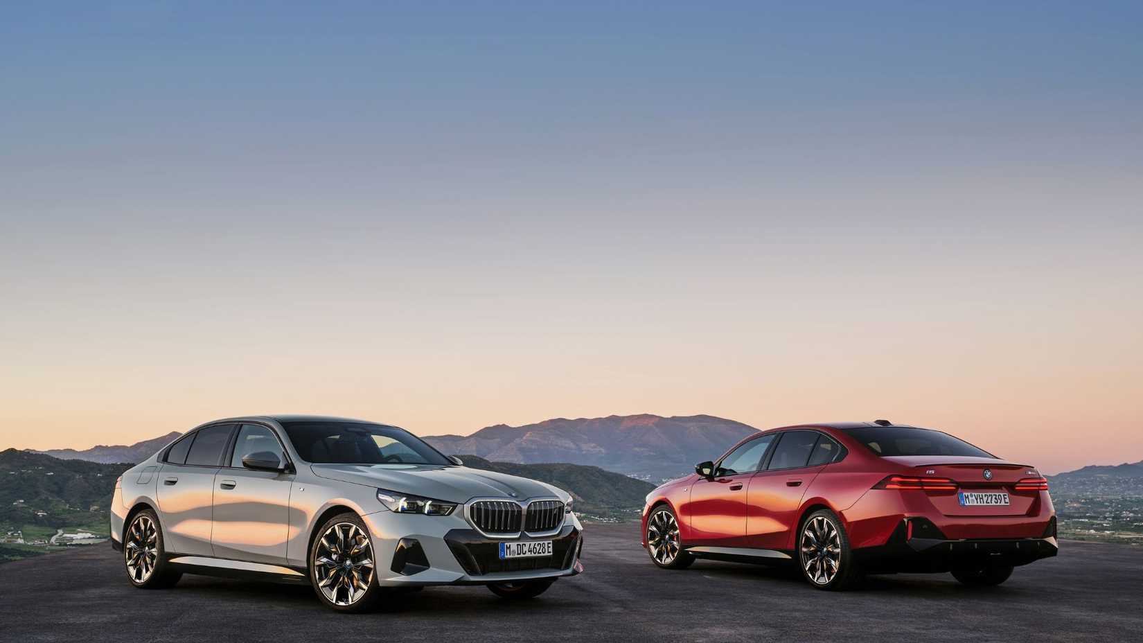The 2024 BMW 5 Series front and rear 3/4 posed side-by-side