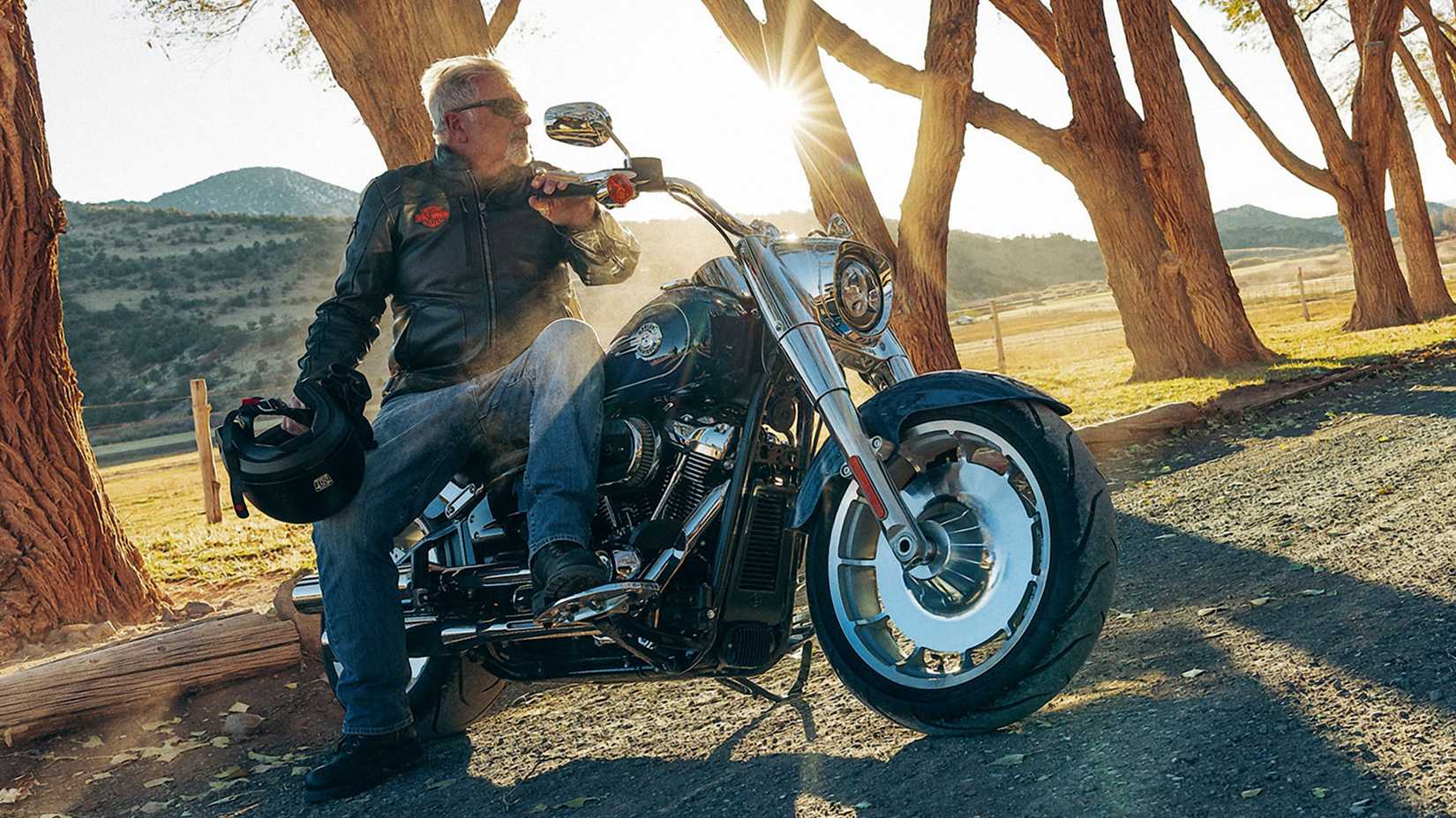 Rider sitting on a blue 2023 Harley-Davidson Fat Boy 114