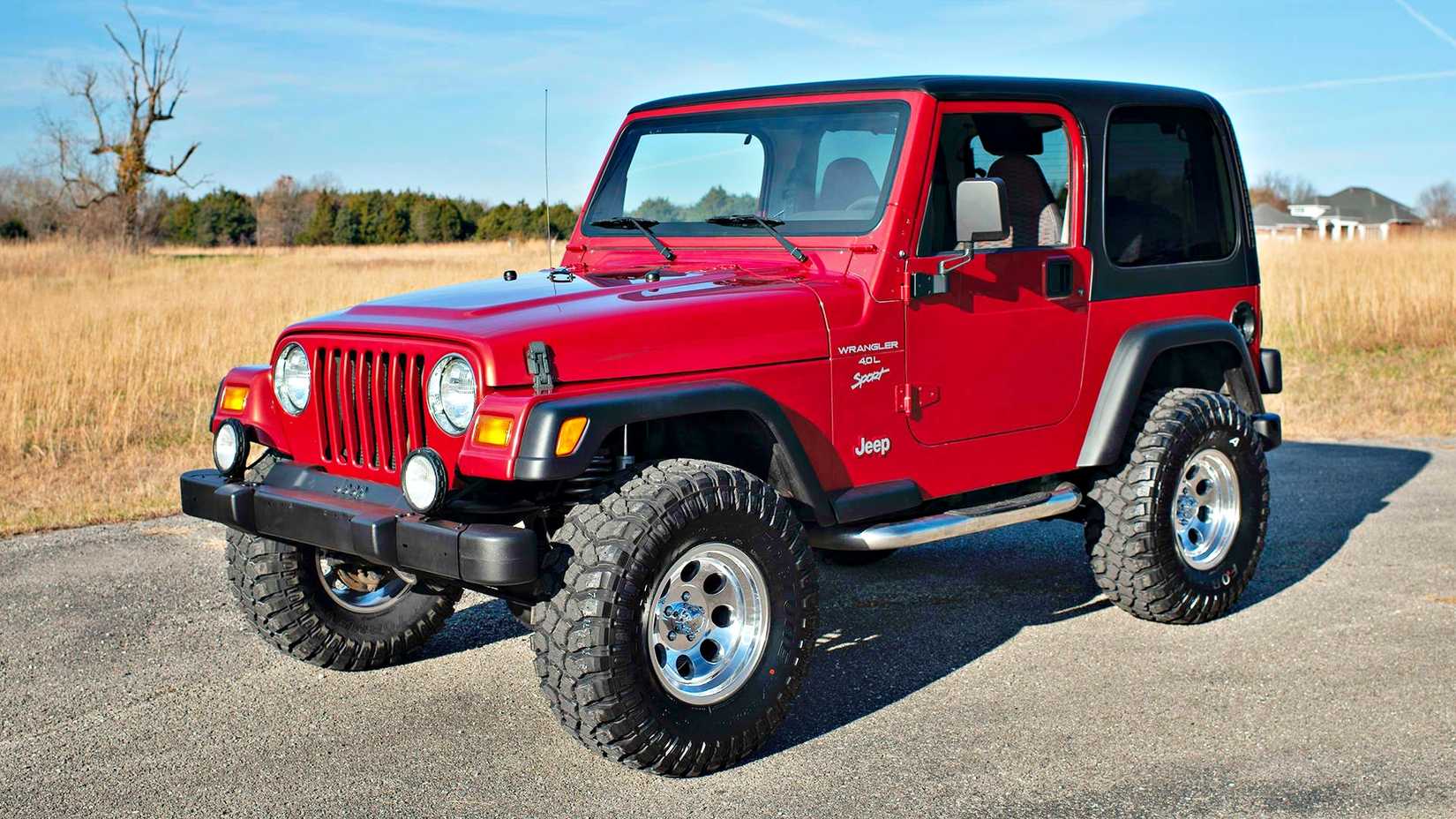 1999 Jeep Wrangler TJ in red parked