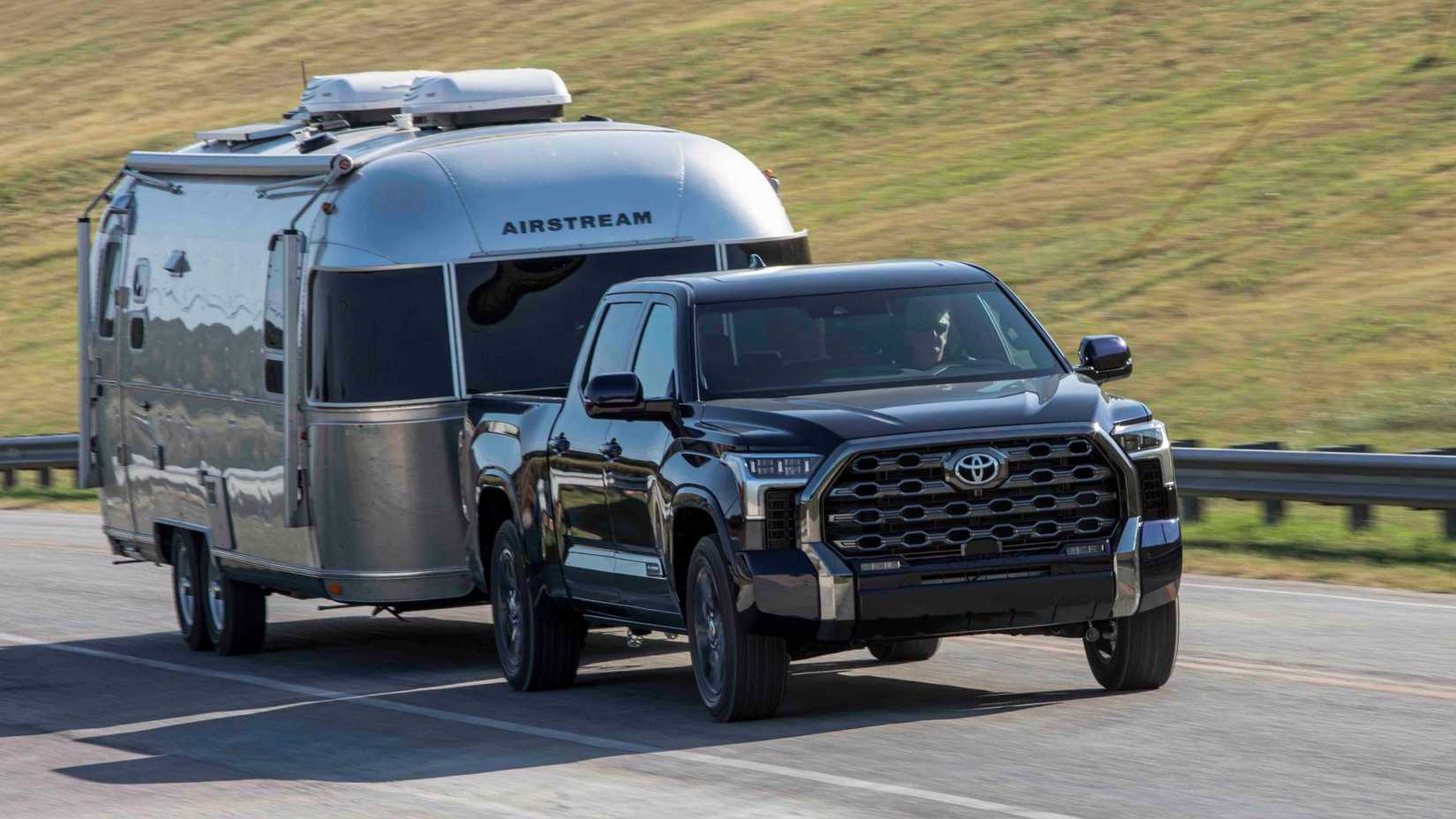 Front 3/4 action shot of 2022 Toyota Tundra towing a trailer