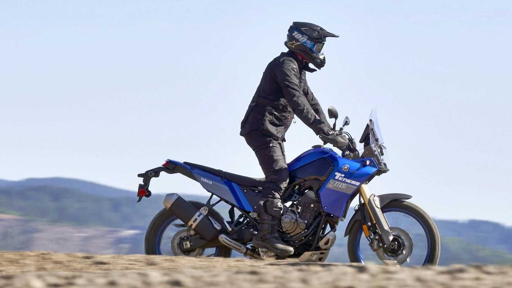 Blue 2024 Yamaha Tenere 700 cruising through open terrain