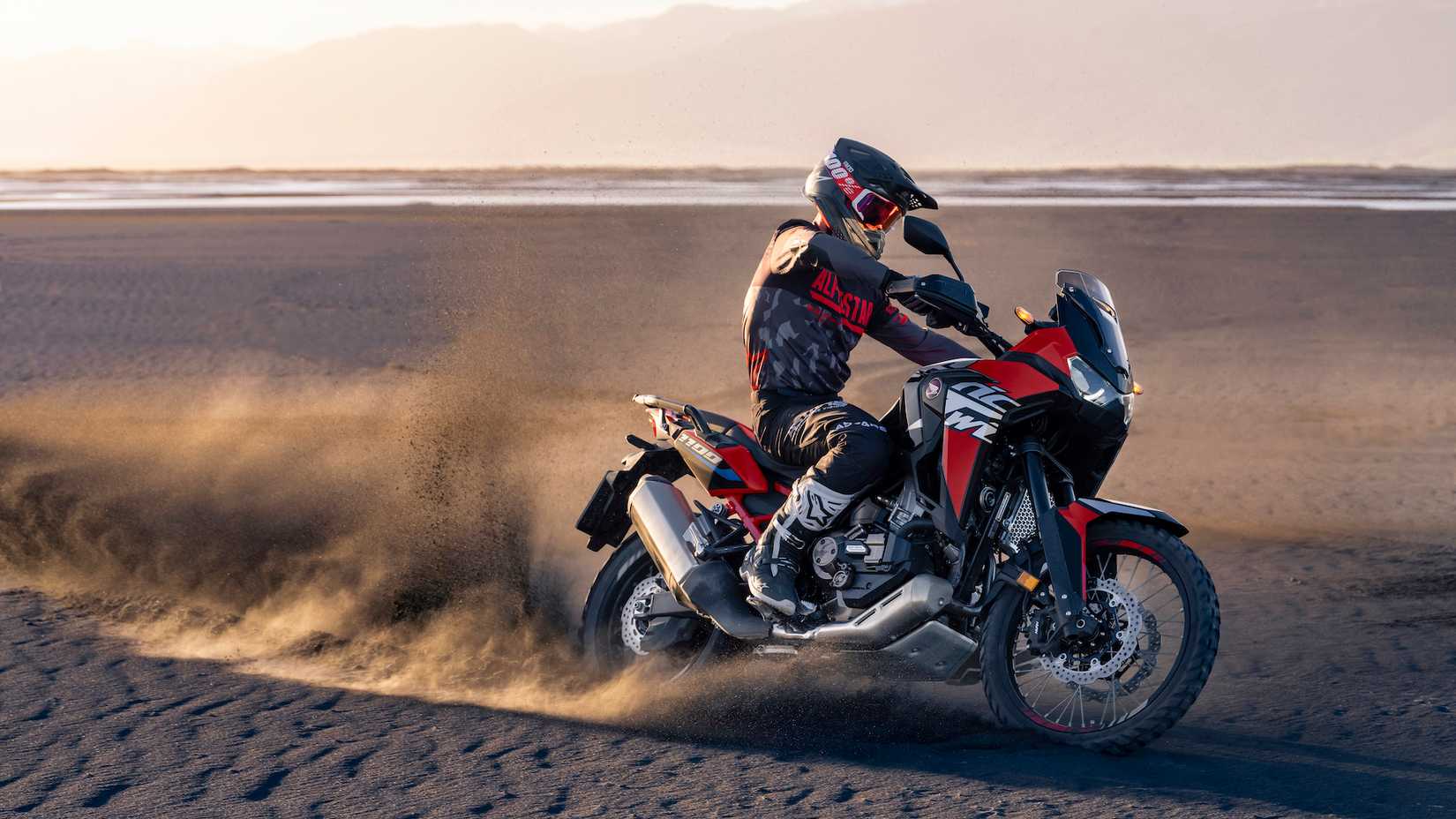 Side shot of the 2022 Honda CRF1100L Africa Twin tackling sandy terain