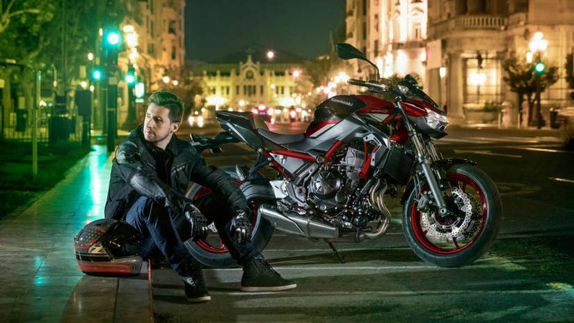 A motorcyclist sitting with the Kawasaki Z650