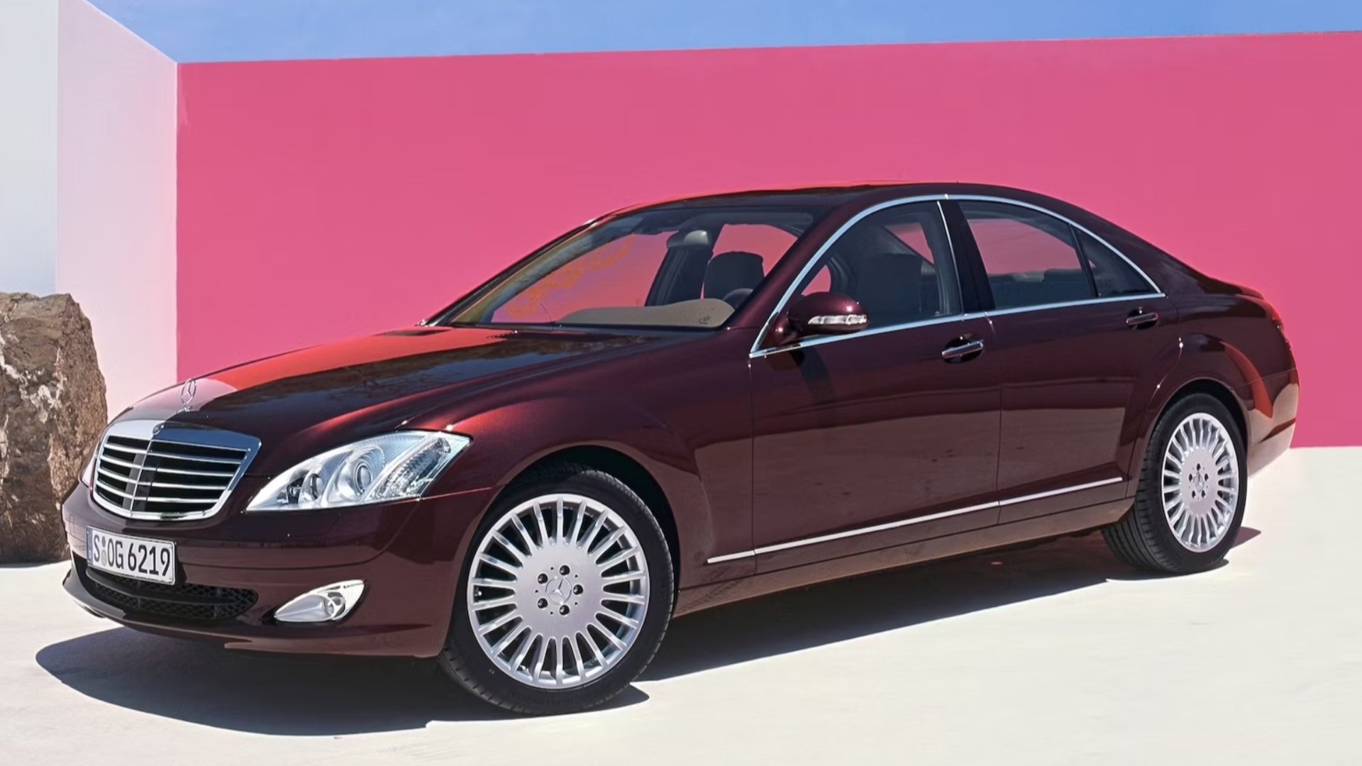A parked burgundy Mercedes S Class W221