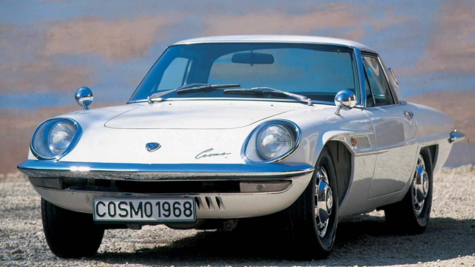 Front shot of a 1968 Mazda Cosmo Sport 110S parked on gravel