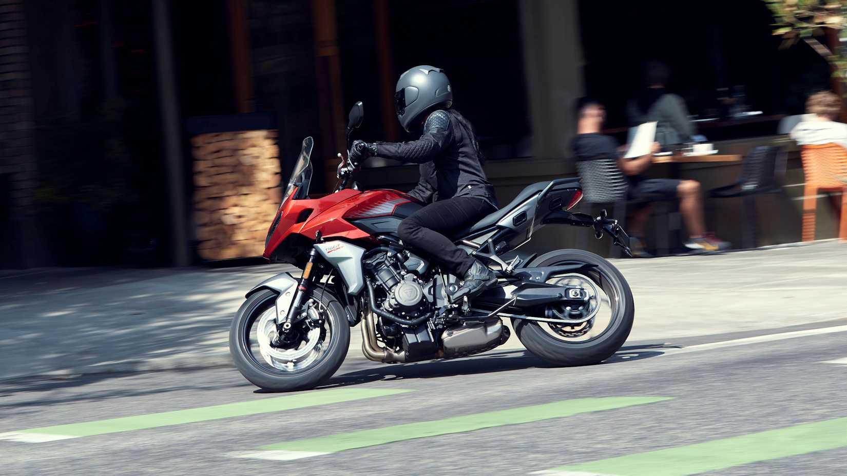 Red 2022 Triumph Tiger Sport 660  cruising through town