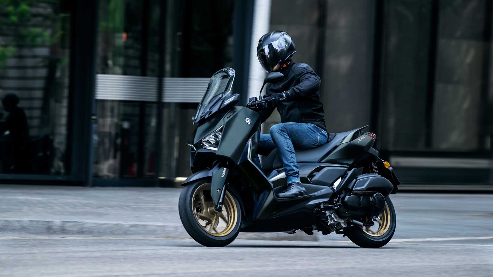 An action shot of a Yamaha XMAX