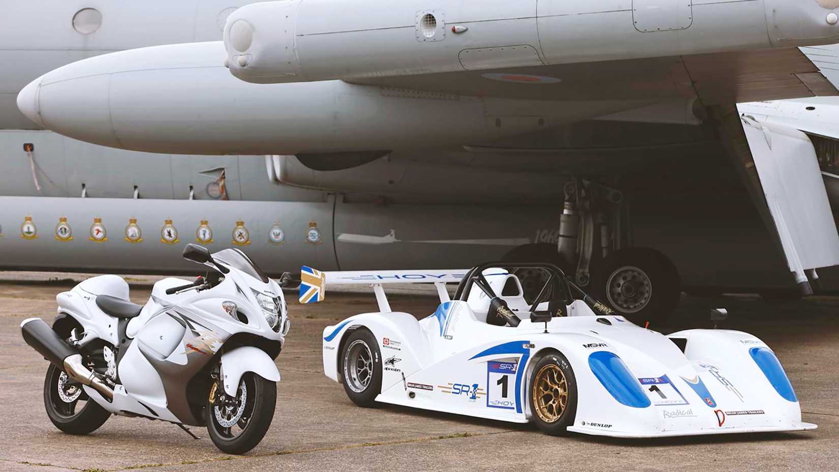 A Suzuki Hayabusa parked on a runway next to a Radical Motorsport SR1 car