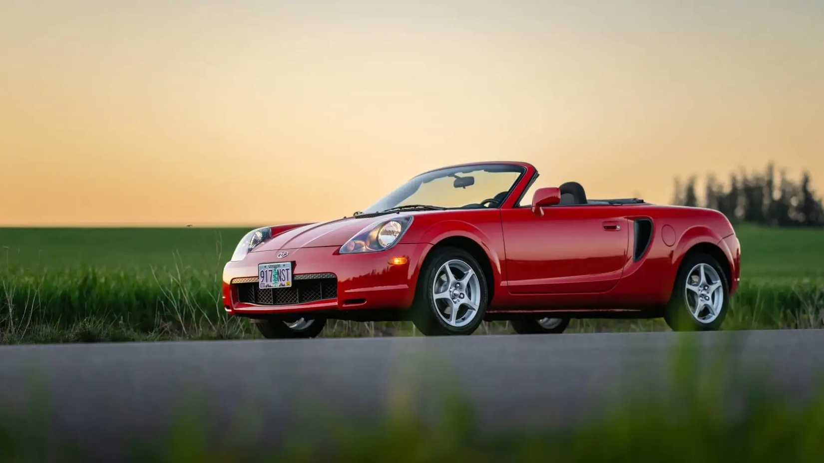 Red Toyota MR2 Spyder side shot parked on the road