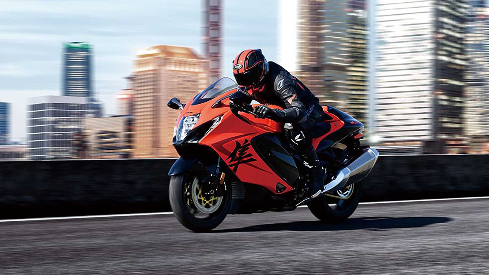 2024 Suzuki Hayabusa 25th Anniversary action shot with city skyline backdrop