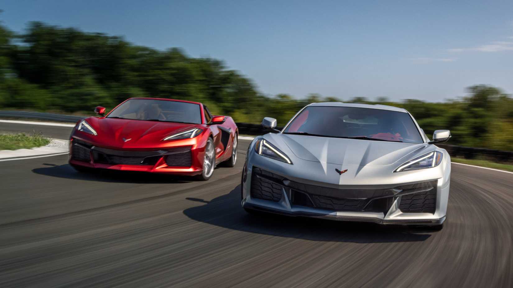 Red and silver 2023 C8 Corvette Z06 side by side on a track