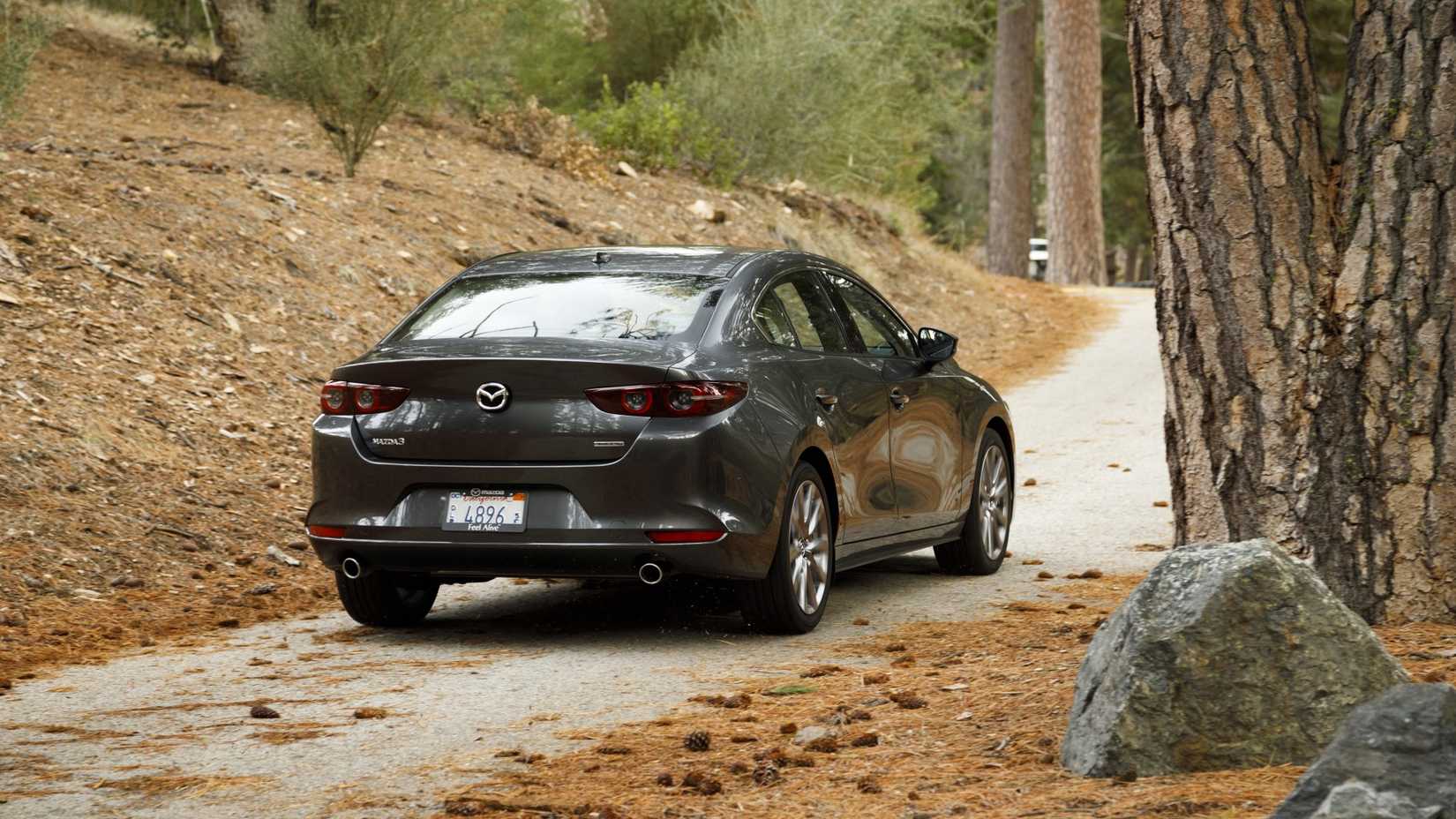Rear end of a Mazda 3 driving through the woods
