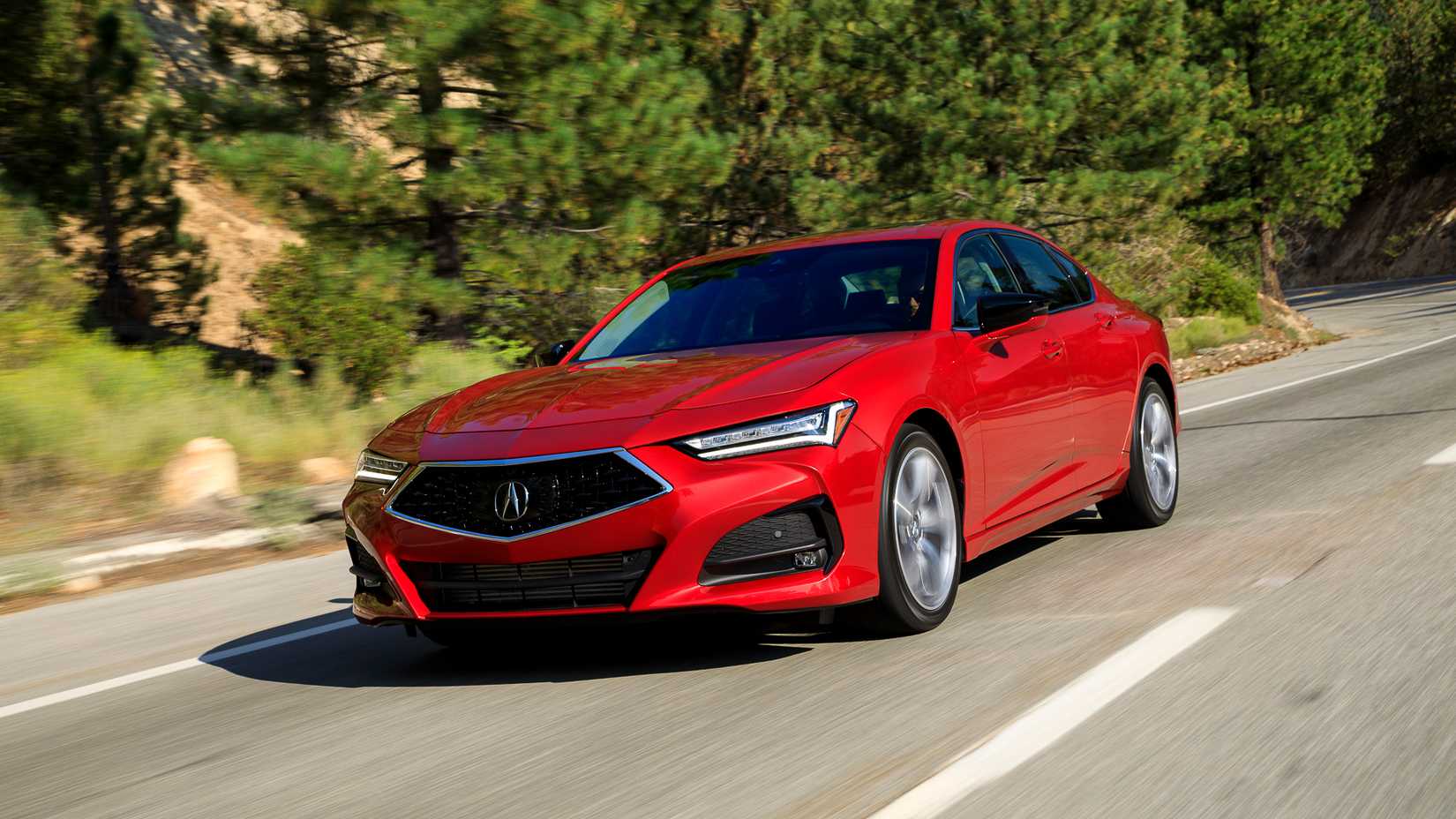 2021-2024 Red Acura TLX cruising down the road