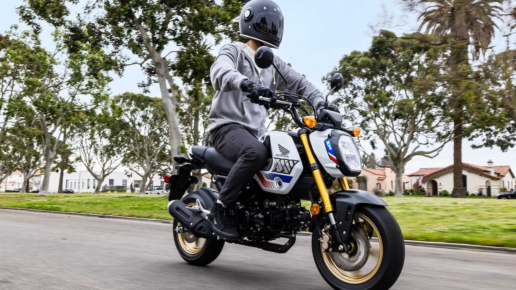 2023 Honda Grom riding down the street