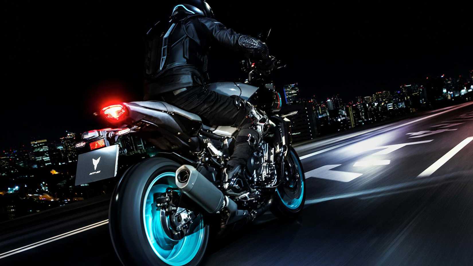 2023 YAMAHA MT-10 naked bike rear action shot at night on a city highway.