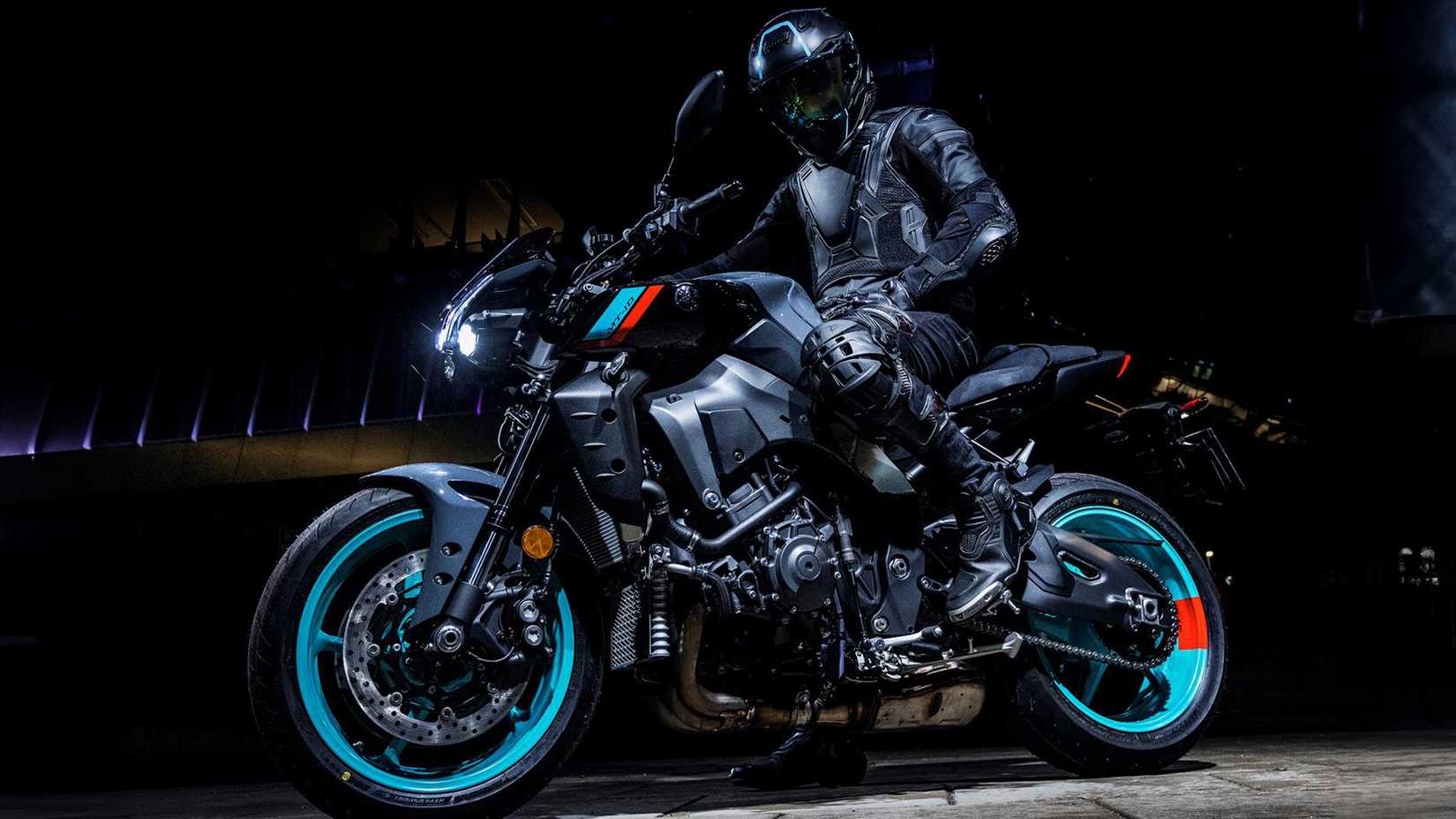 2023 Yamaha MT-10 naked bike and rider shot at night from a side view.