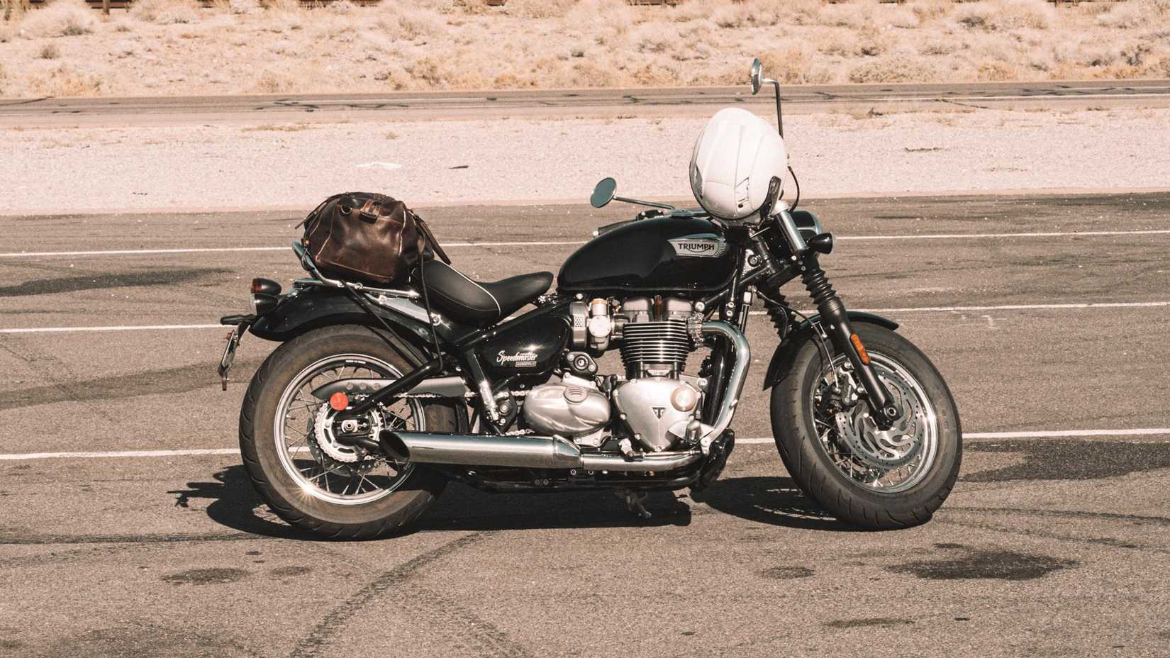 Right side profile shot of a 2023 Triumph Bonneville Speedmaster in a desert parking lot.