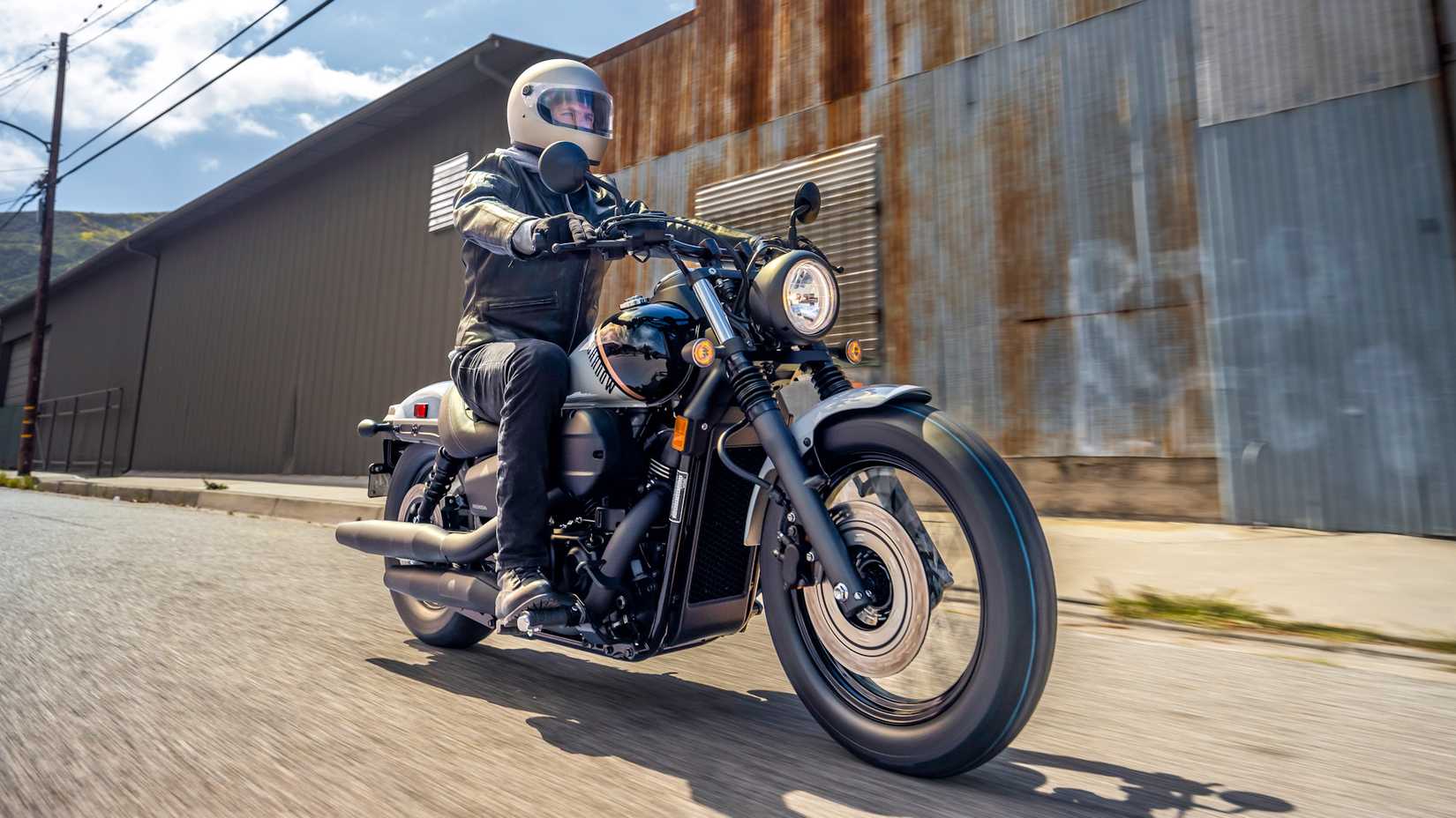 Honda Shadow Phantom cruising through an industrial area