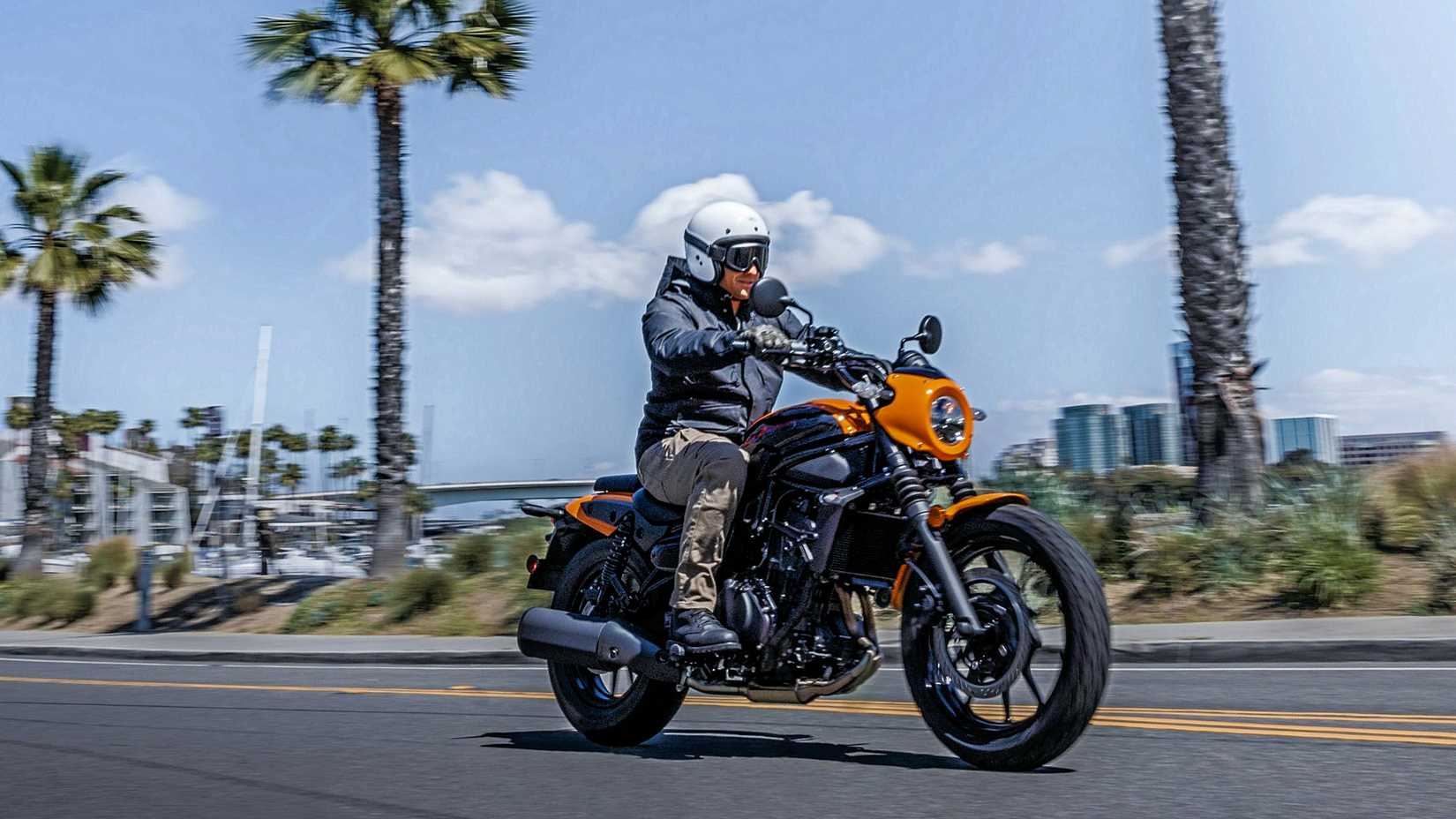 Orange 2024 Kawasaki Eliminator SE cruising on the road